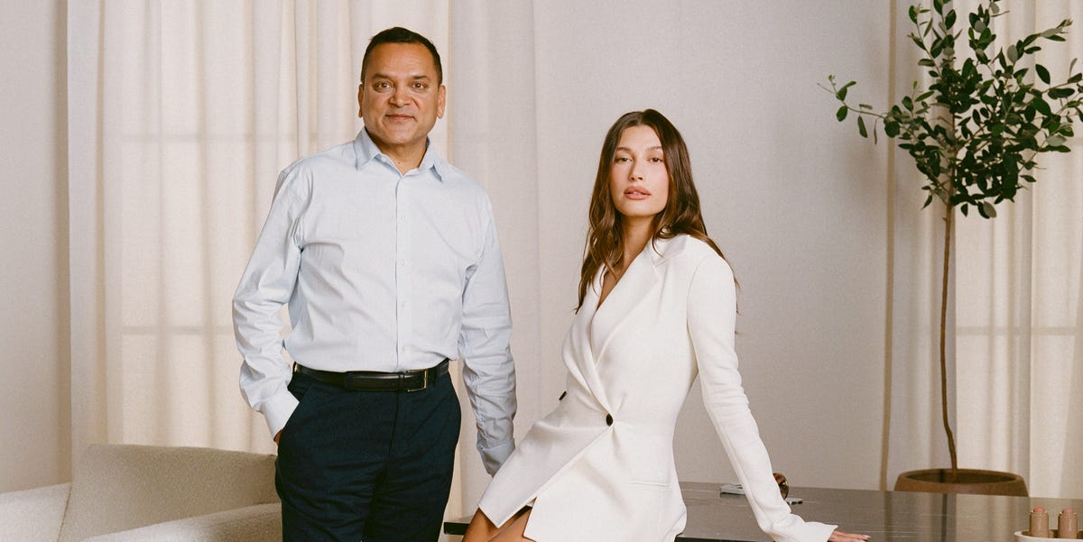 a man and a woman posing together in a modern interior setting a man and a woman posing together in a modern interior setting