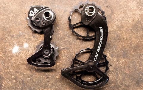 The OSPW is much larger than the stock Shimano Dura Ace Di2 pulley cage (left)