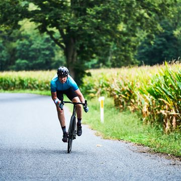 a woman riding a bicycle on a road