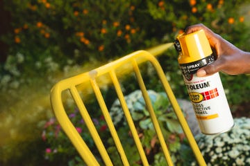 spray painting a chair yellow