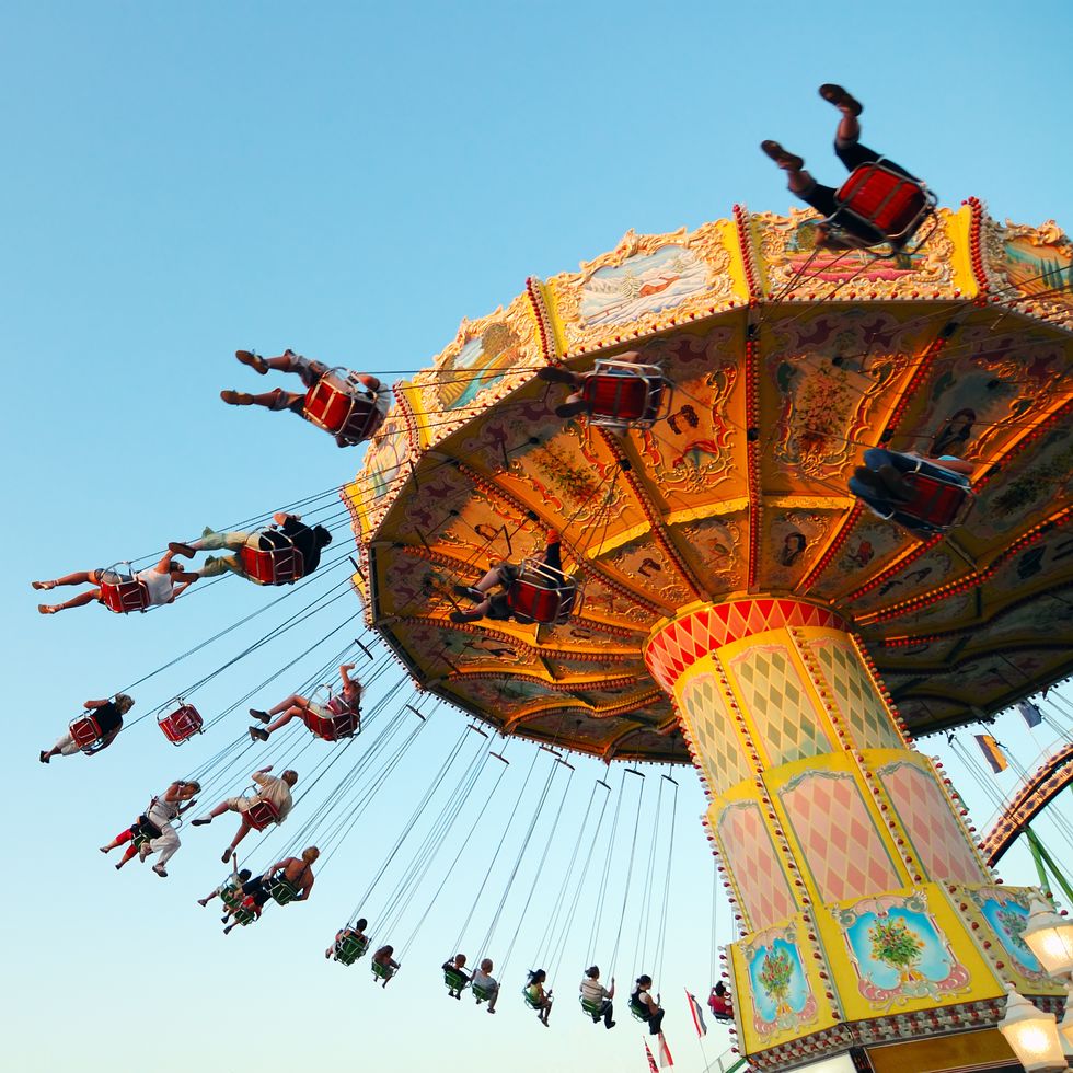 teens on a chairoplane in an amuseument park