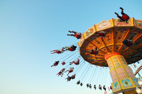 teens on a chairoplane in an amuseument park