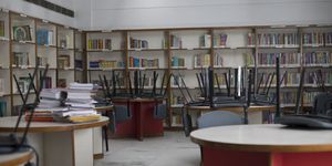 chairs upside down on tables in public library