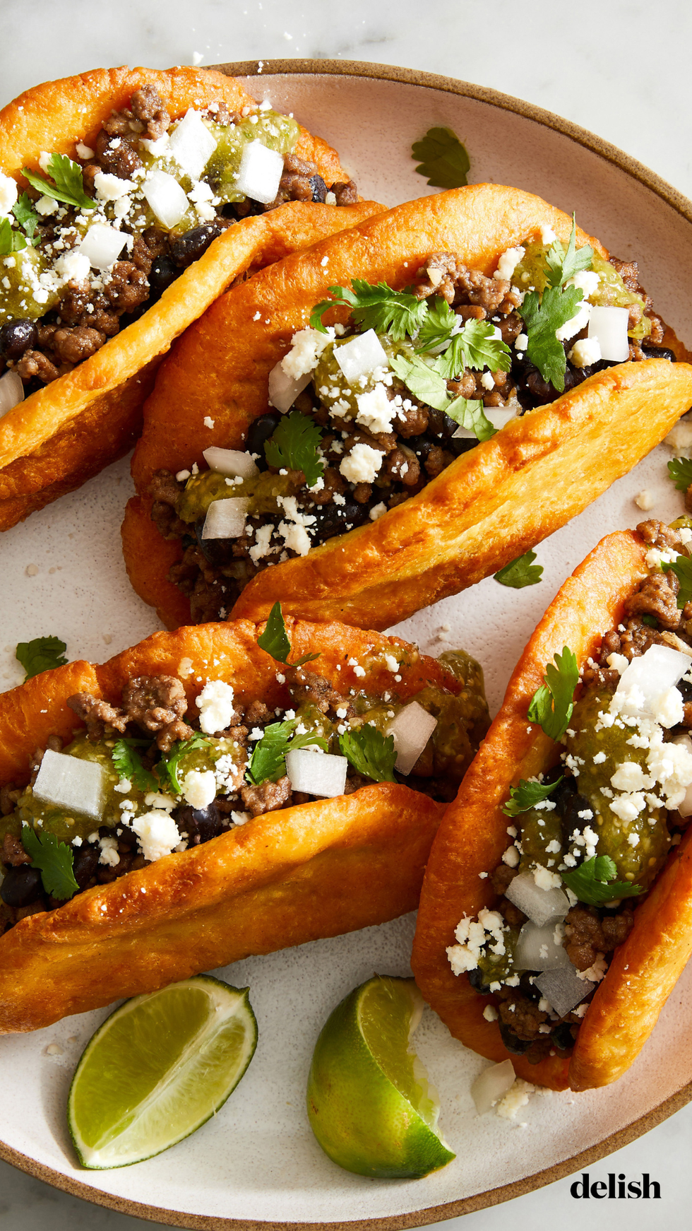 chalupas with ground beef beans onions cojita and salsa verde