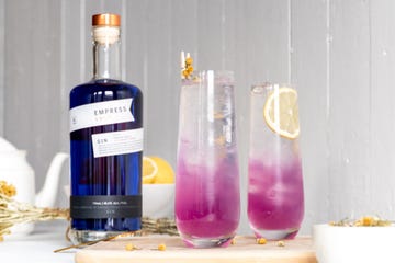 empress 1908 indigo gin color changing purple gin bottle of wine next to a couple of glasses with purple liquid