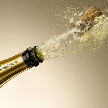 champagne and cork exploding from bottle