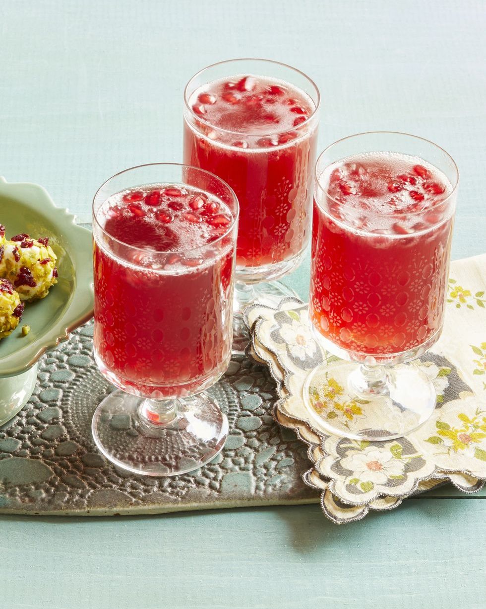 pomegranate sparklers with floral napkin and snacks on tray