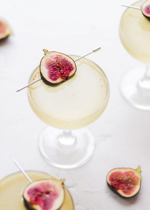 sparkling fig cocktail in coupe glass with fresh figs