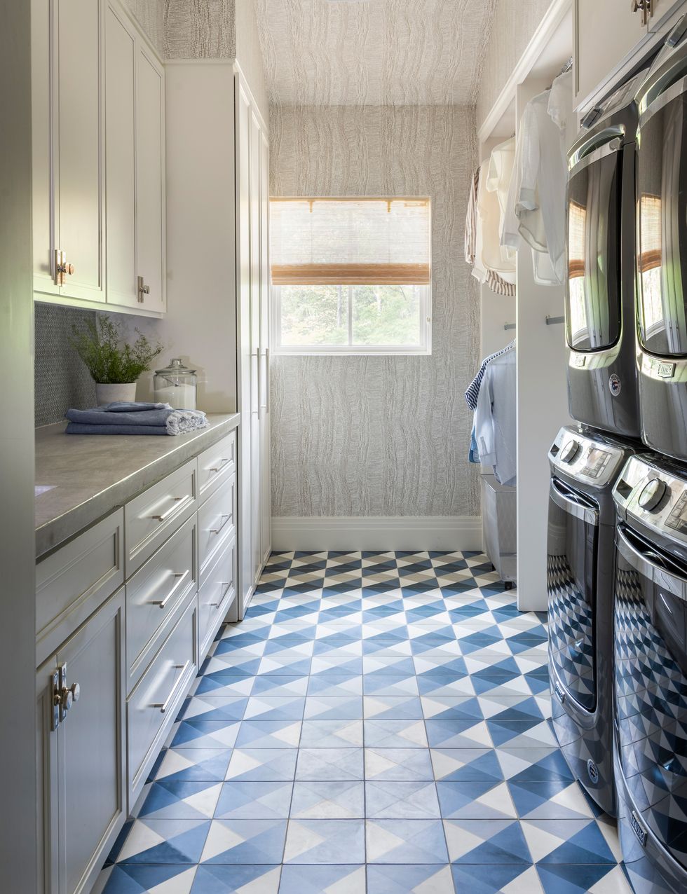 a laundry room with blue and white tile