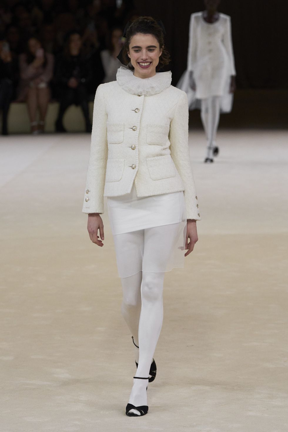 margaret qualley wears a white ruff suit at the chanel couture show