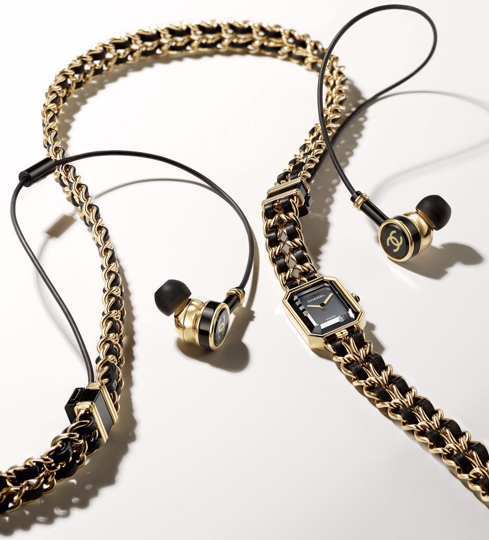 a flat shot of embellished headphones and watch and jewelry combination