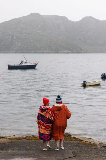 two ladies wearing changing robes for cold water swimming