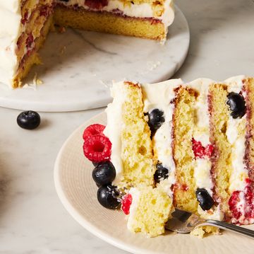 chantilly cake topped with raspberries and blueberries