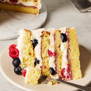 chantilly cake topped with raspberries and blueberries