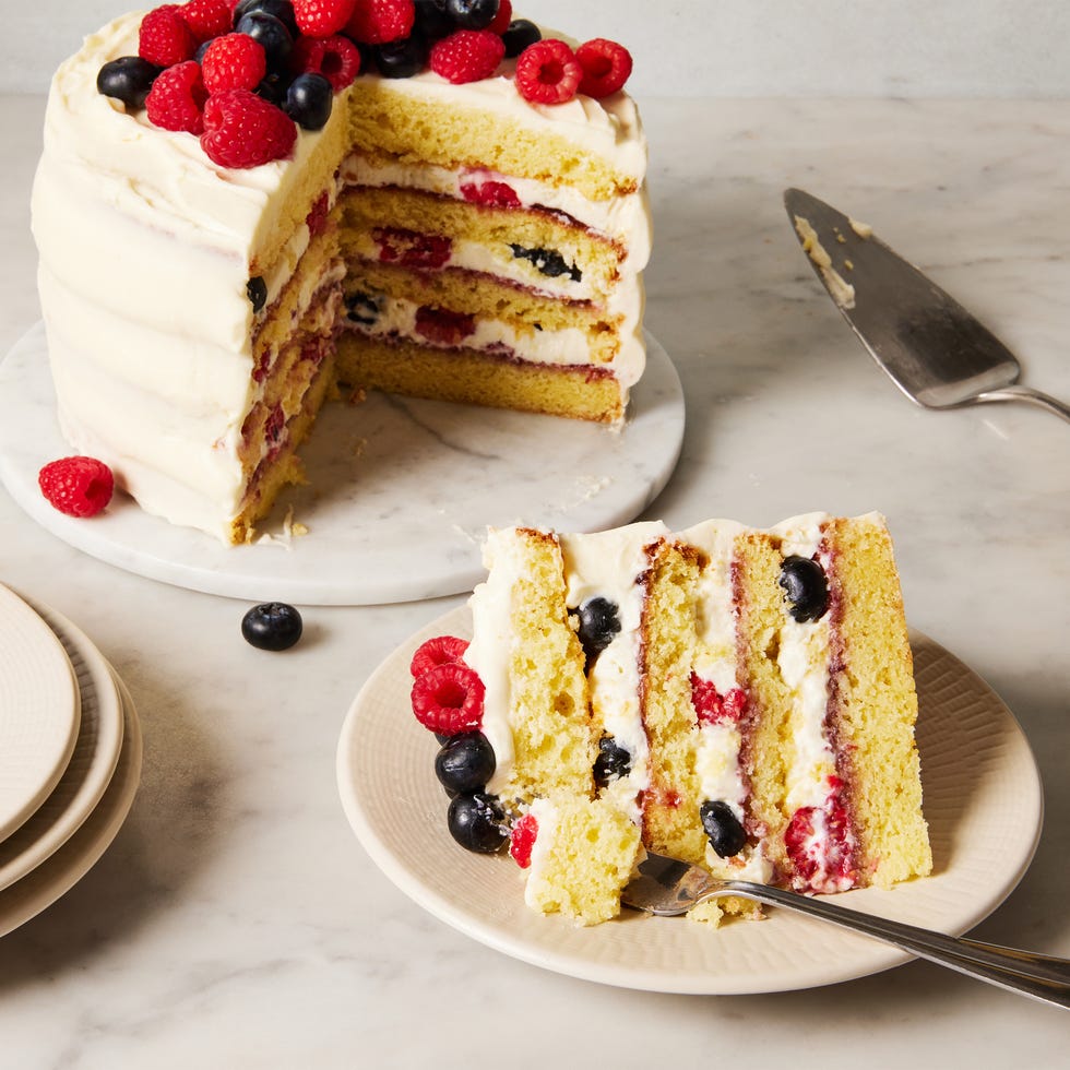 chantilly cake topped with raspberries and blueberries