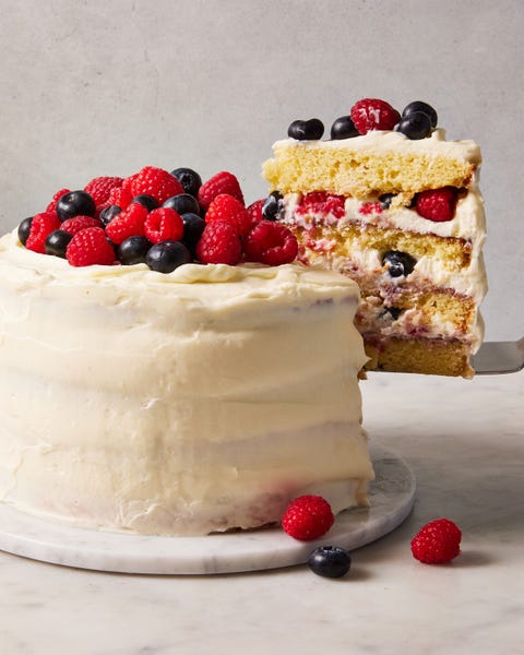 chantilly cake topped with raspberries and blueberries