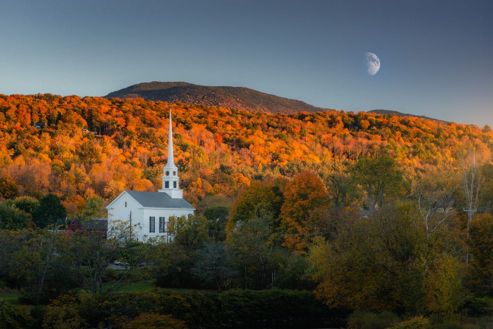 a chapel surround by autumn forest in stowe vermont