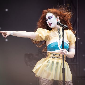 a singer performing on stage holding a microphone