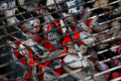 charcoal burning under a grill at a barbeque