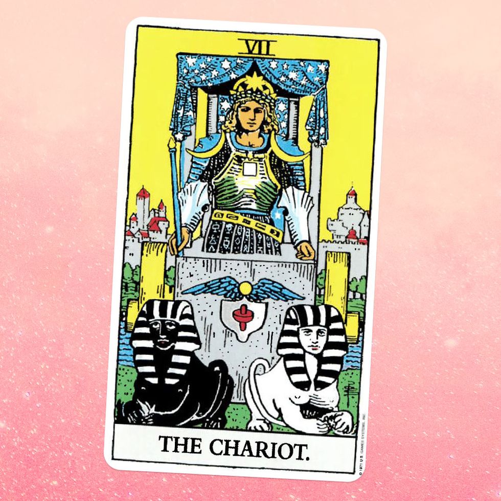 the tarot card the chariot, showing a person in armor sitting in a silver chariot, pulled by two sphinxes