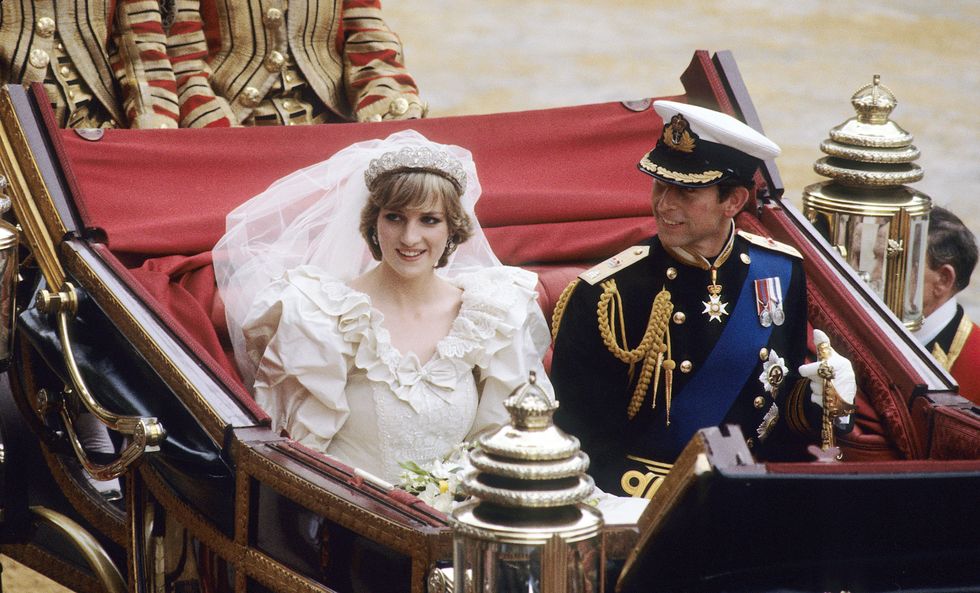 london, england   july 29 prince charles, prince of wales and diana, princess of wales, wearing a wedding dress designed by david and elizabeth emanuel and the spencer family tiara, ride in an open carriage, from st pauls cathedral to buckingham palace, following their wedding on july 29, 1981 in london, england   photo by anwar husseinwireimage