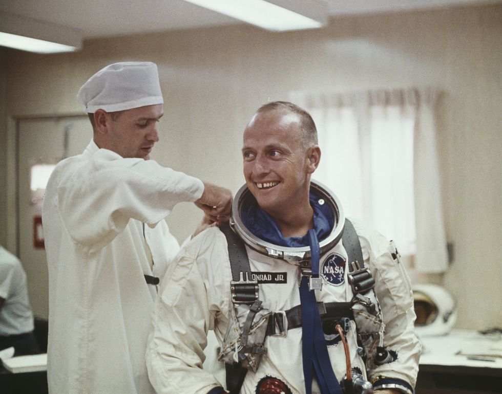Pete Conrad pictured being assisted in to his Gemini space suit for a Project Gemini training exercise in the United States circa 1965.