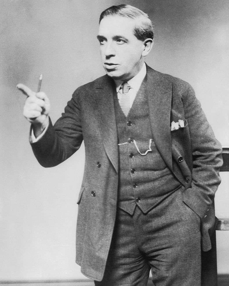 charles ponzi pointing while holding a pencil in his hand