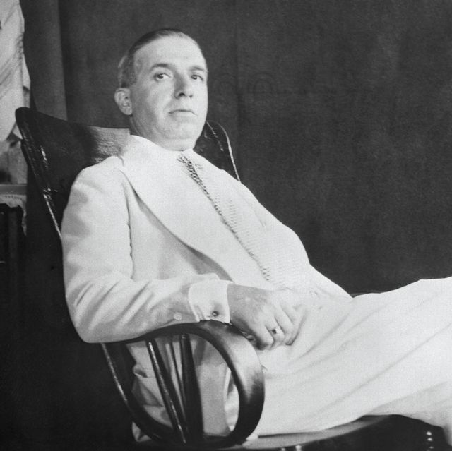 a man relaxes in an armchair and looks at the camera