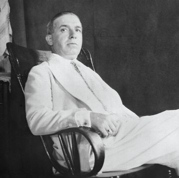 a man relaxes in an armchair and looks at the camera