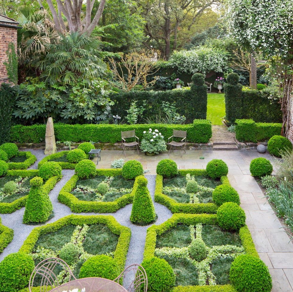 18th century charleston, south carolina, home design by ben lenhardt in the parterre garden, kingsville boxwood borders with corner globes of japanese boxwood frame variegated asiatic jasmine knots and smaller spheres of oregano