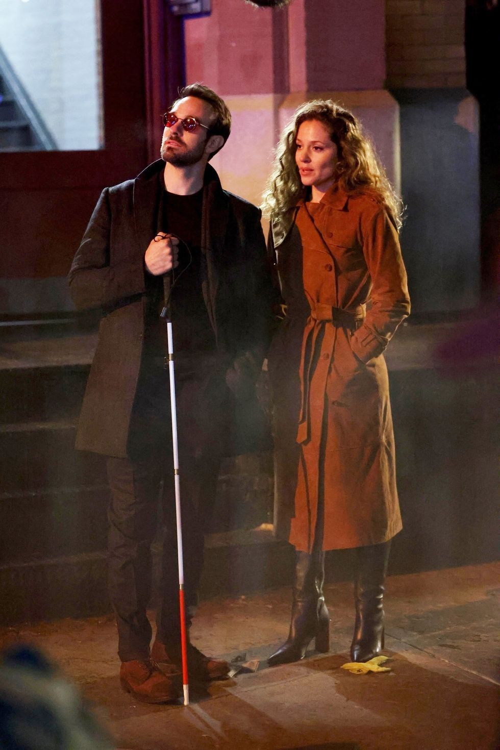 a man and woman standing next to each other and holding a microphone