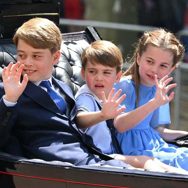 charlotte and louis wave and sit alongside george in a carriage
