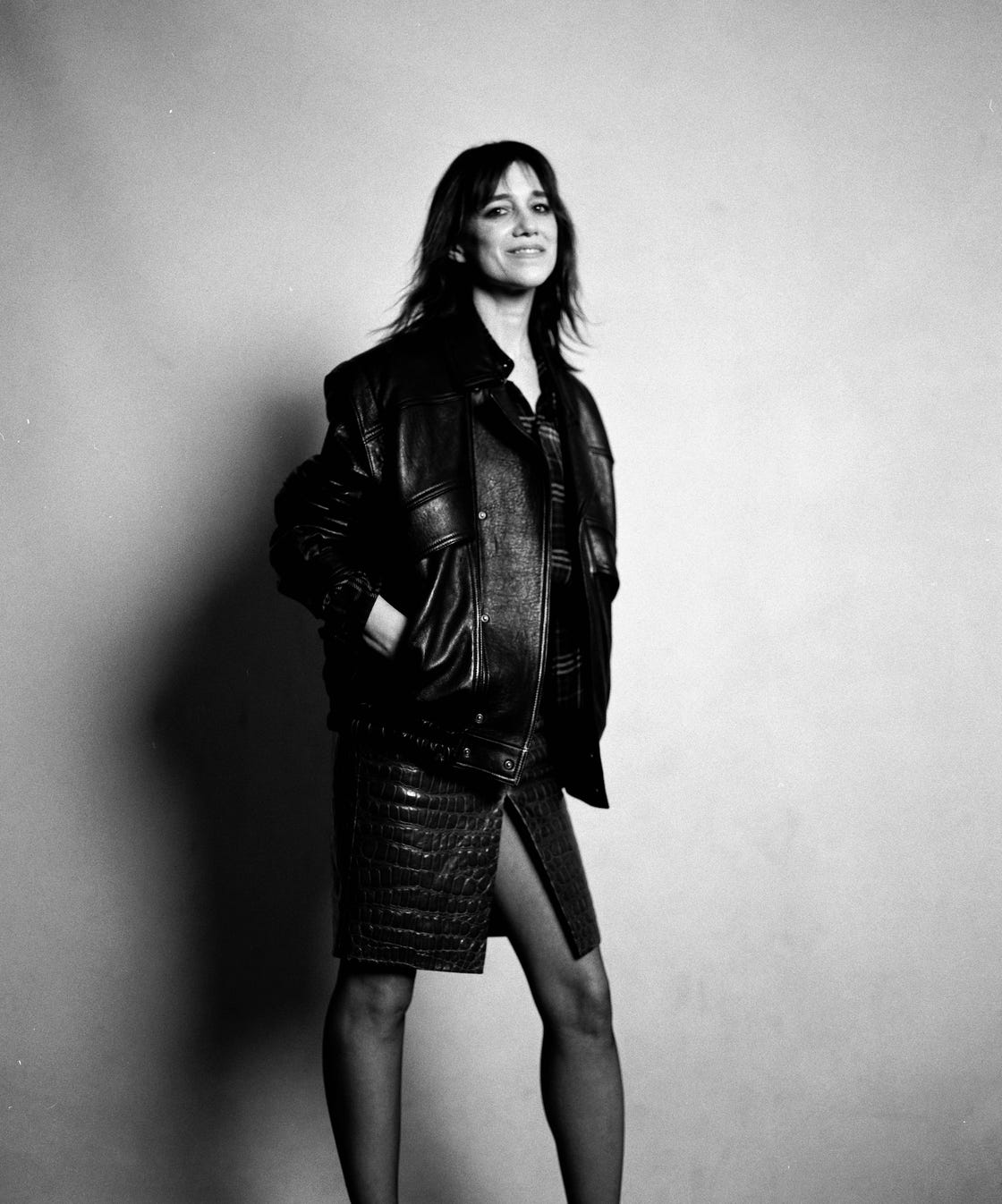 fashion model wearing a black leather jacket and a textured skirt