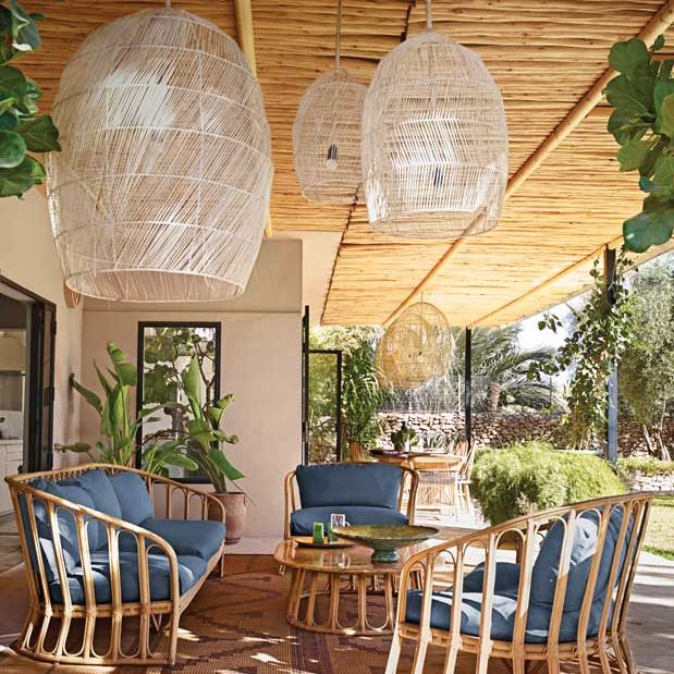 Outdoor terrace with wooden seating and large pendant lights