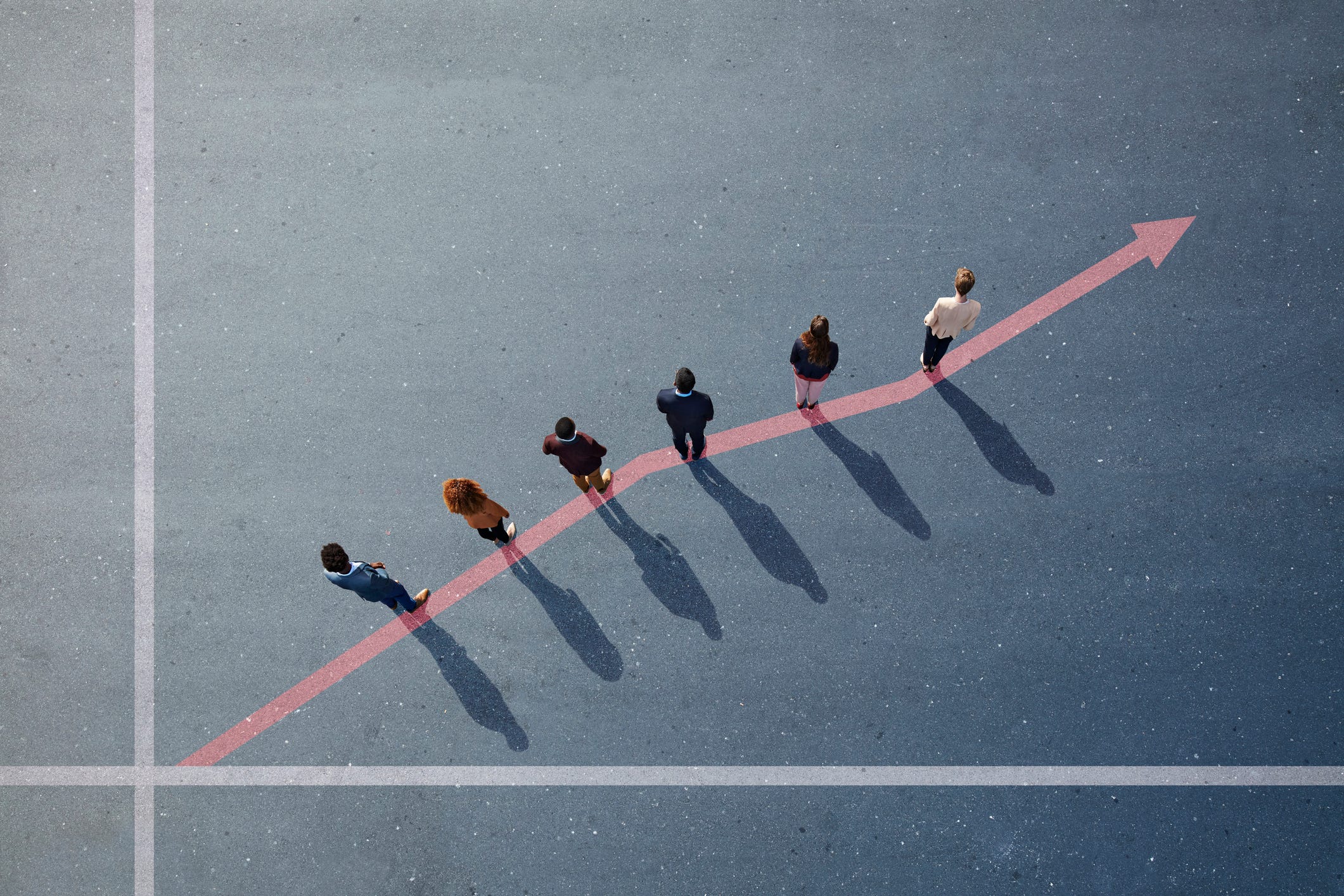 Businesspeople standing on painted up going graph on asphalt