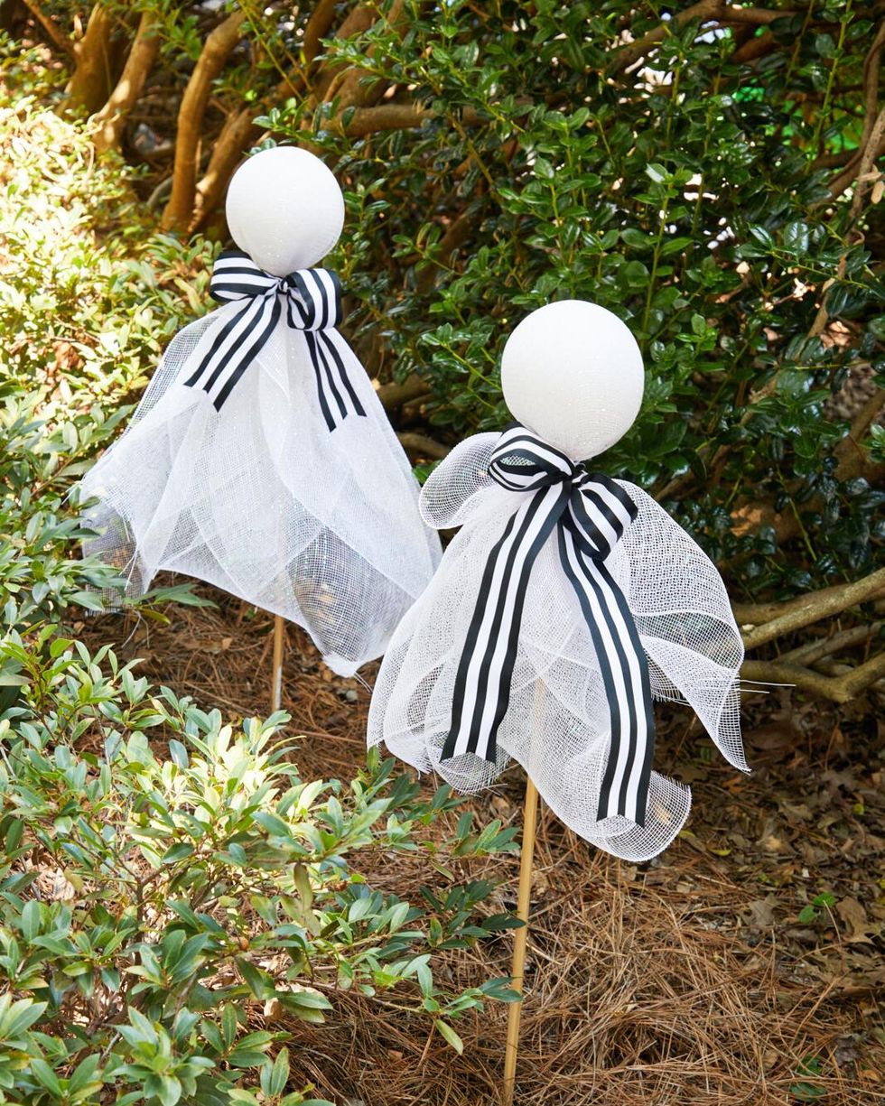 styrofoam balls with stakes intserted in the bottom wrapped in large glittery ribbon to look like ghosts
