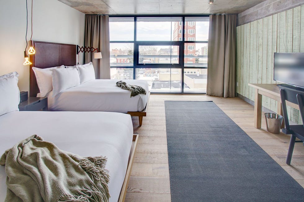a hotel room with two beds and a large window