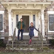as seen on hgtv's cheap old houses, hosts ethan and elizabeth pose for a portrait at a historical home in gasport, ny