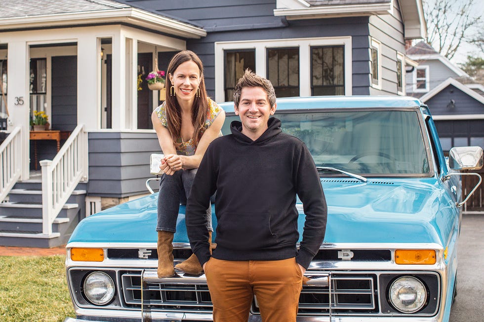 As seen on HGTV's Cheap Old Houses, host Elizabeth poses for a photo in a historic bungalow in Rochester, New York