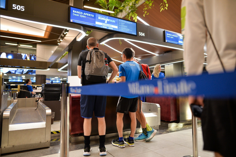 a few men standing at a counter