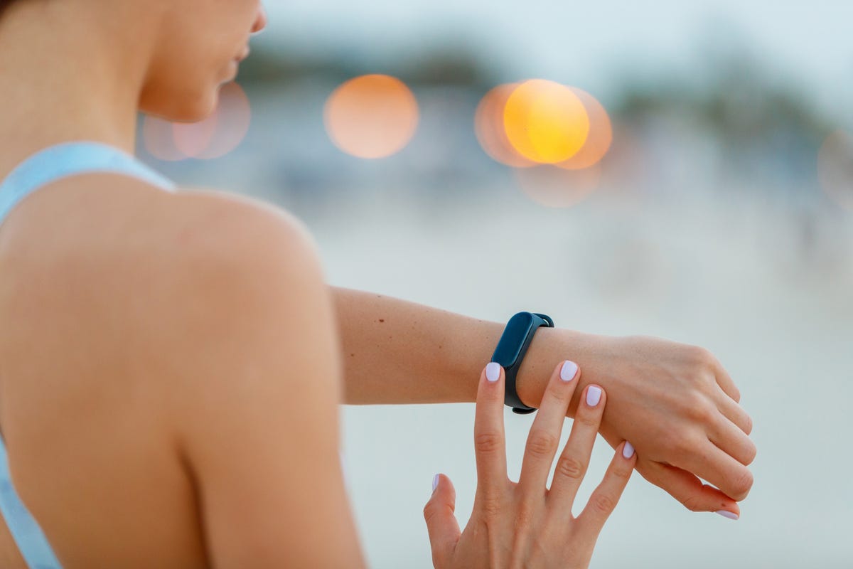 Checking the fitness tracker on her wrist
