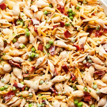 pasta noodles tossed with bacon, peas, and cheddar cheese all tossed in a creamy sauce