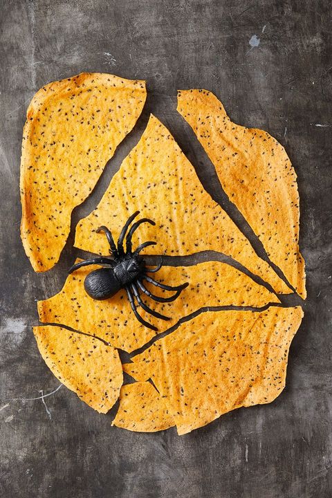 cheddar crackers with a plastic black toy spider