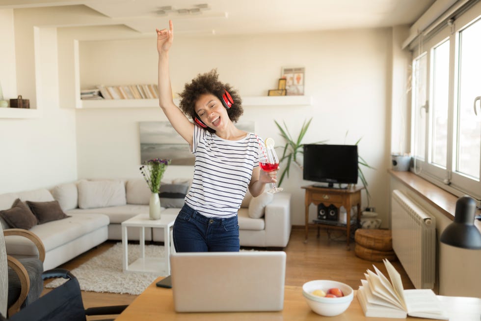 cheerful african american woman partying at home