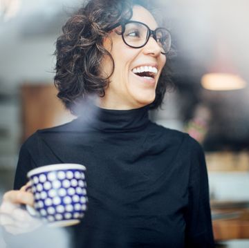 cheerful businesswoman at coffee shop