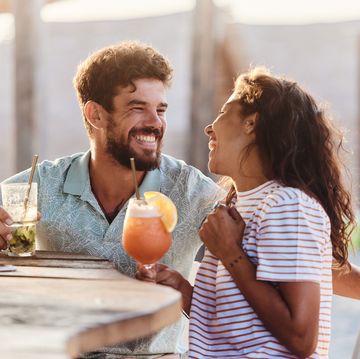 cheerful couple talking in a bar
