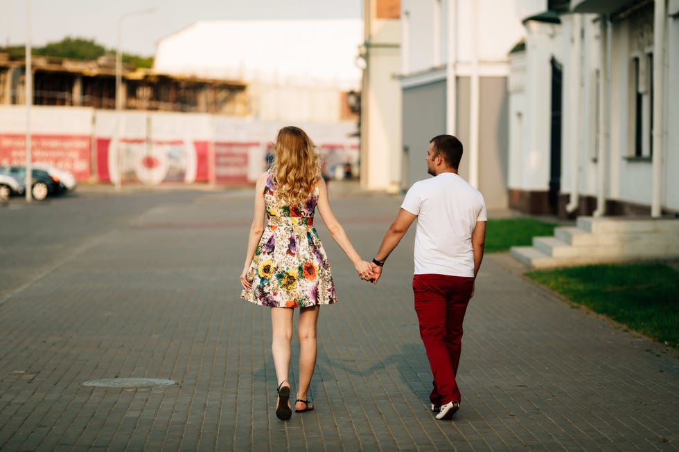 cheerful couple walking through the city together