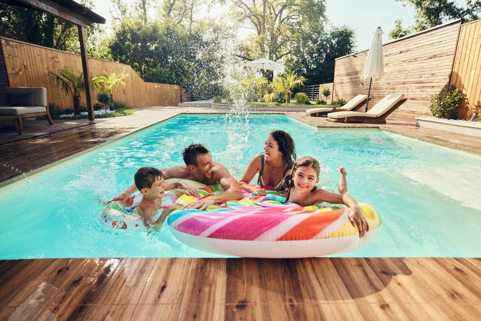 cheerful family at the pool in family friendly labor day activities