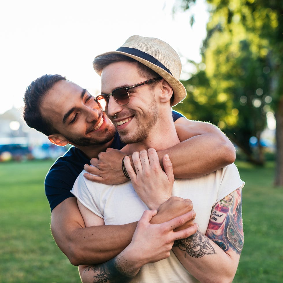 cheerful gay couple expressing love to each other while on vacation