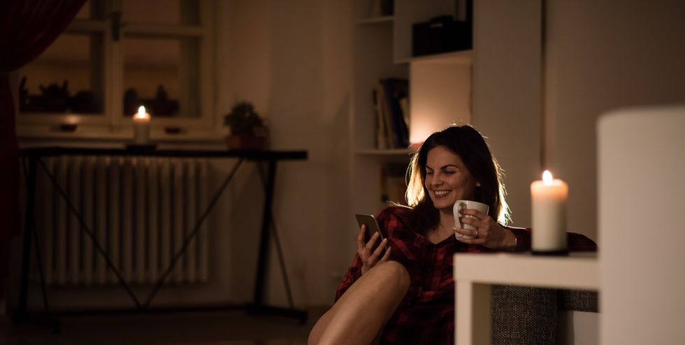 cheerful relaxed woman in her apartment having coffee